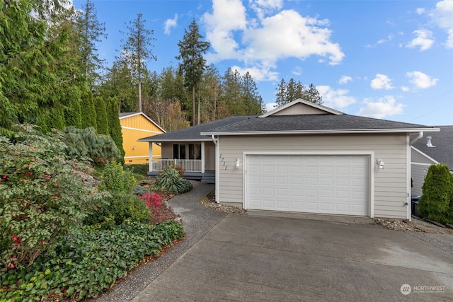 single story home featuring a porch and a garage