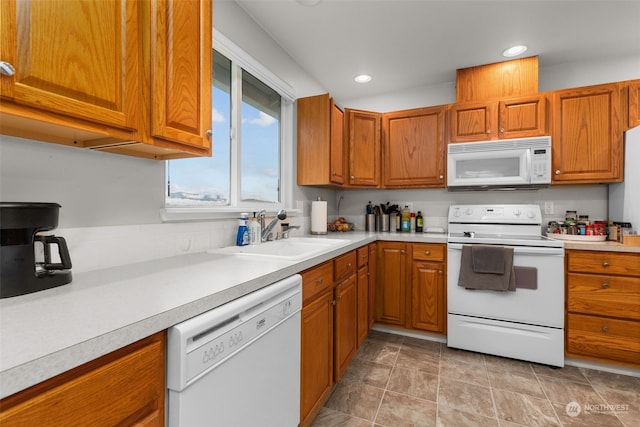 kitchen featuring white appliances and sink