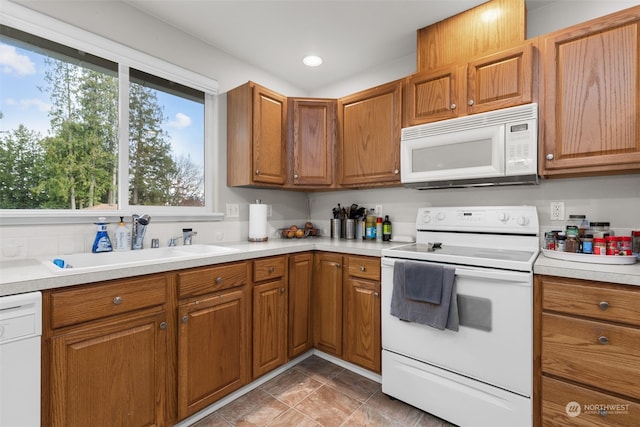 kitchen with sink and white appliances