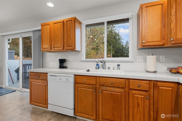 kitchen featuring a wealth of natural light, sink, and dishwasher