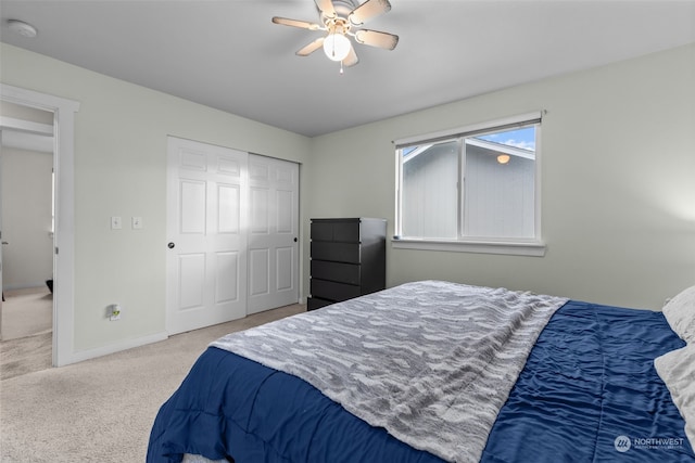 carpeted bedroom featuring a closet and ceiling fan