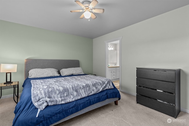 bedroom with light carpet, connected bathroom, and ceiling fan