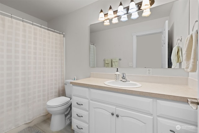 bathroom with vanity, toilet, and tile patterned floors