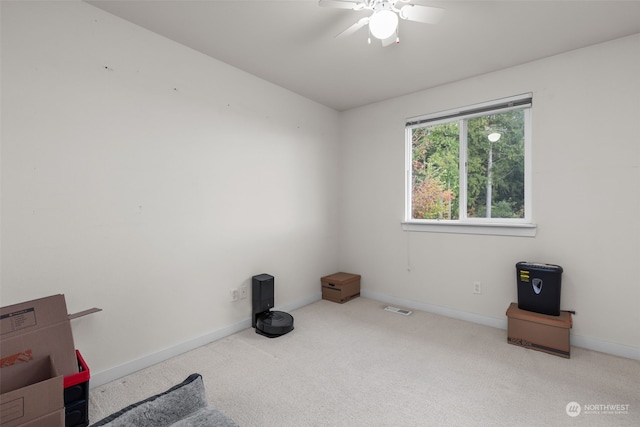 interior space with light carpet and ceiling fan