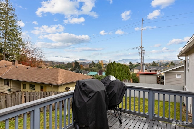 deck with a lawn and grilling area