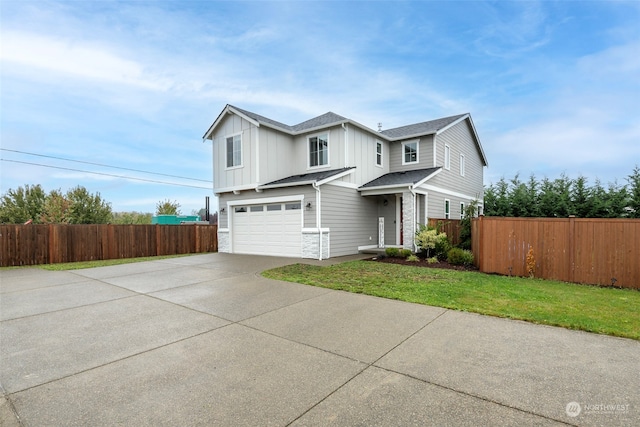 view of front of property with a front yard and a garage