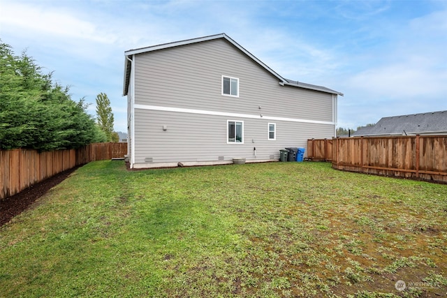 back of house featuring a lawn