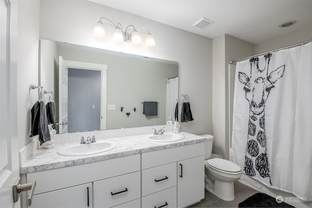 bathroom with tile patterned floors, vanity, and toilet