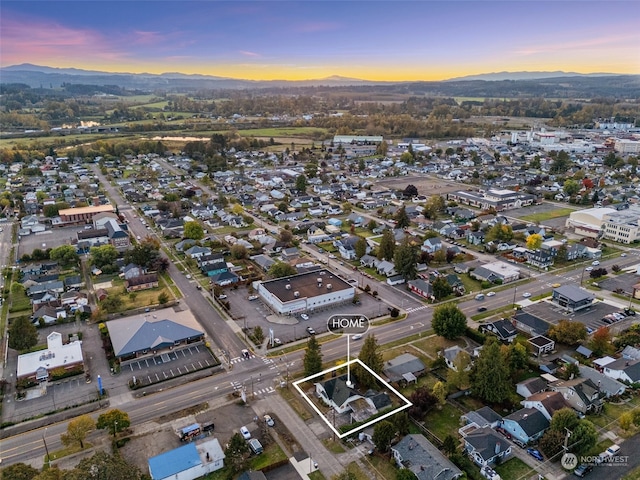 aerial view at dusk featuring a mountain view