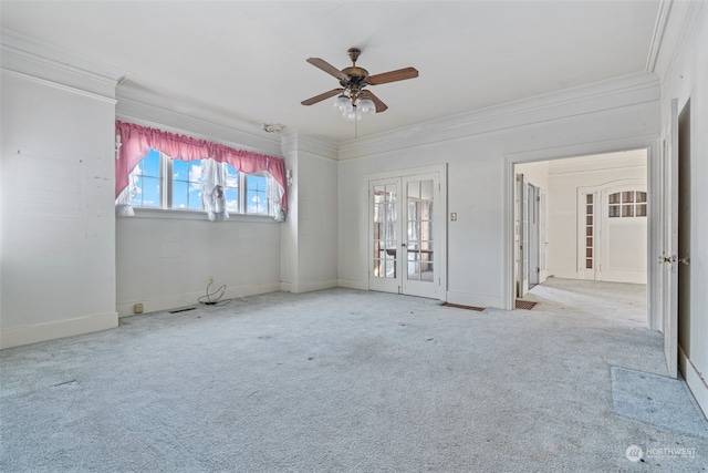 spare room with french doors, crown molding, light colored carpet, and ceiling fan