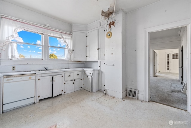 kitchen with white cabinetry, sink, and white dishwasher