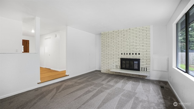 unfurnished living room featuring carpet floors and a fireplace