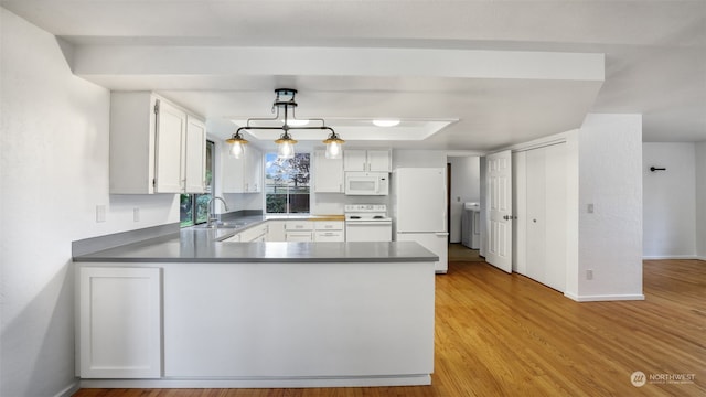 kitchen with white appliances, decorative light fixtures, light hardwood / wood-style floors, and white cabinets