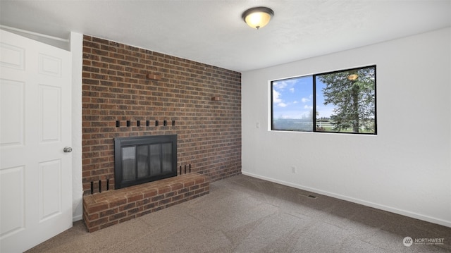 unfurnished living room with a fireplace and carpet flooring