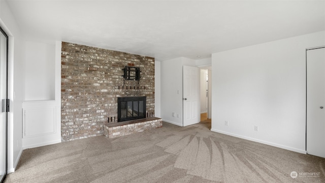 unfurnished living room featuring carpet floors and a fireplace