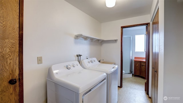 clothes washing area featuring sink and washer and dryer