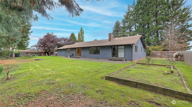 rear view of property featuring a yard