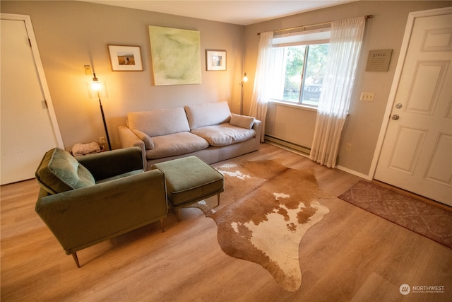 living room with light hardwood / wood-style floors and baseboard heating