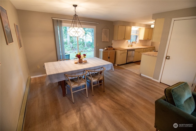 dining room featuring light wood-type flooring and sink