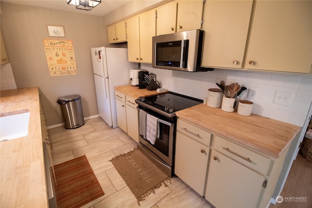 kitchen with appliances with stainless steel finishes and decorative backsplash