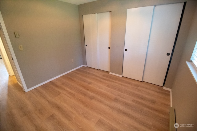 unfurnished bedroom featuring light wood-type flooring