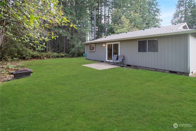 back of property with a yard and a patio area