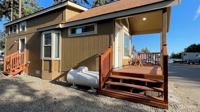 view of side of home with a wooden deck