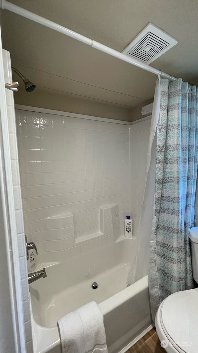 bathroom featuring shower / bath combination with curtain, wood-type flooring, and toilet