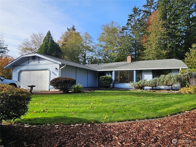 ranch-style home with a front lawn and a garage