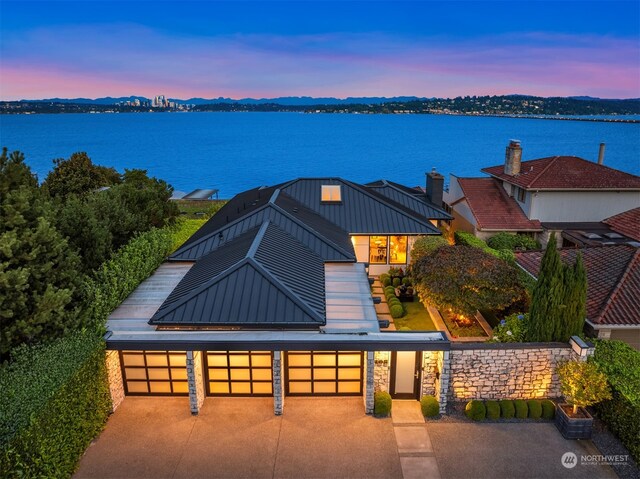 view of front of home with a water view