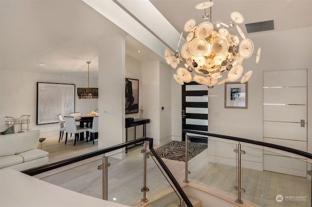 interior space featuring hardwood / wood-style flooring and a notable chandelier