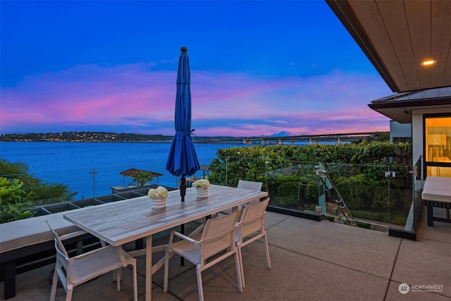 patio terrace at dusk with a water view