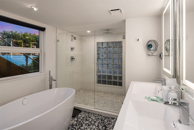 bathroom featuring plus walk in shower and vanity