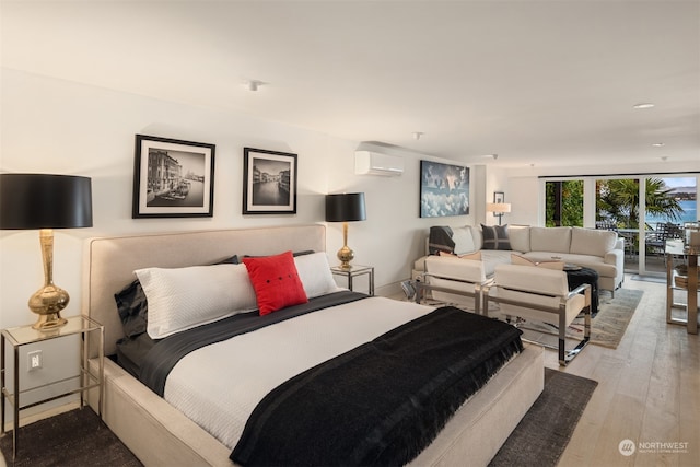 bedroom with access to outside, a wall mounted air conditioner, and light hardwood / wood-style floors