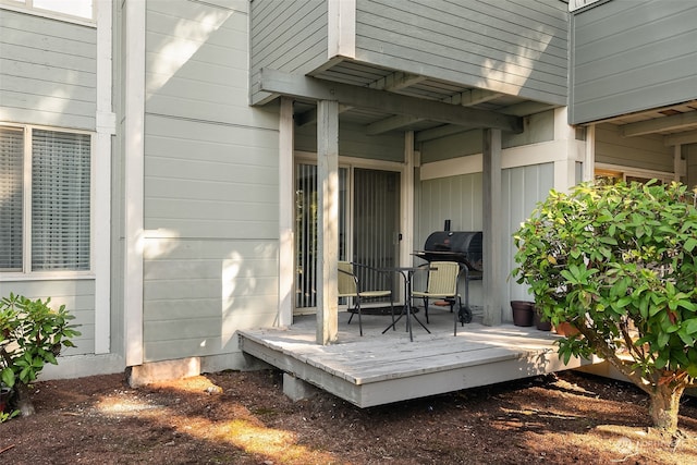 wooden terrace with a grill