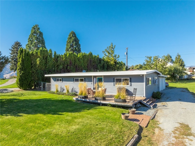 view of front of property with a front lawn and a deck