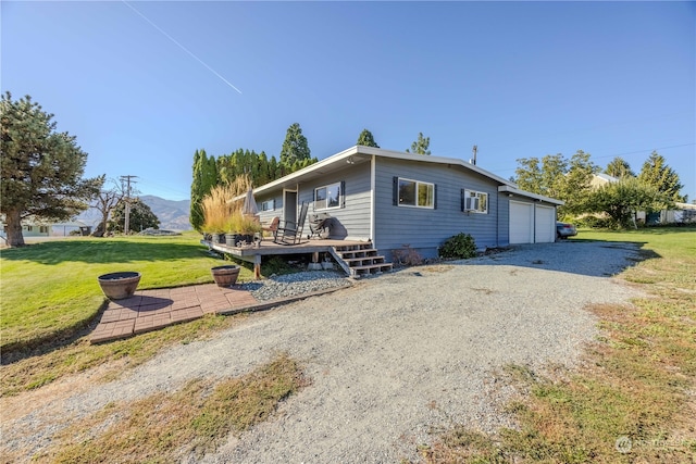 view of home's exterior featuring a garage, a yard, and a wooden deck