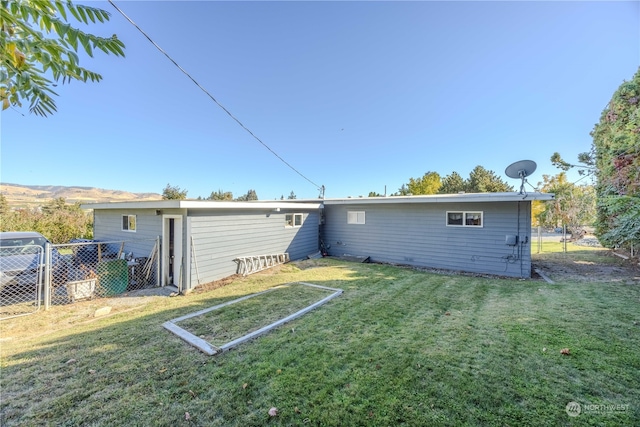 rear view of property featuring a yard