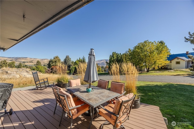 deck featuring a yard and a mountain view