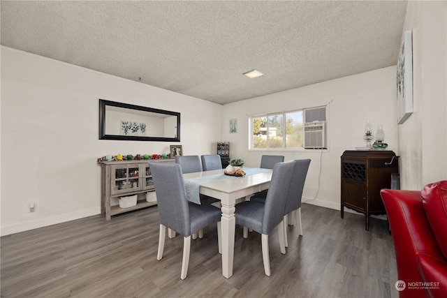 dining space featuring dark hardwood / wood-style flooring and a textured ceiling