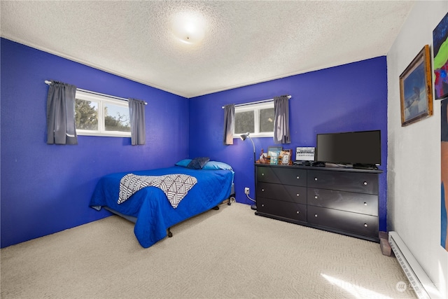 carpeted bedroom with a baseboard radiator and a textured ceiling