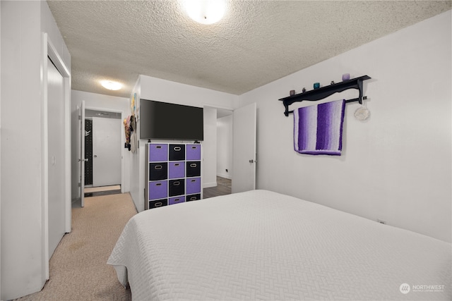 carpeted bedroom featuring a textured ceiling