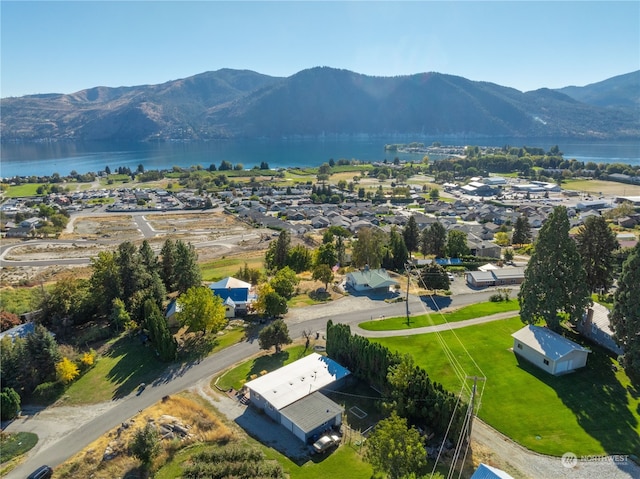 birds eye view of property with a water and mountain view