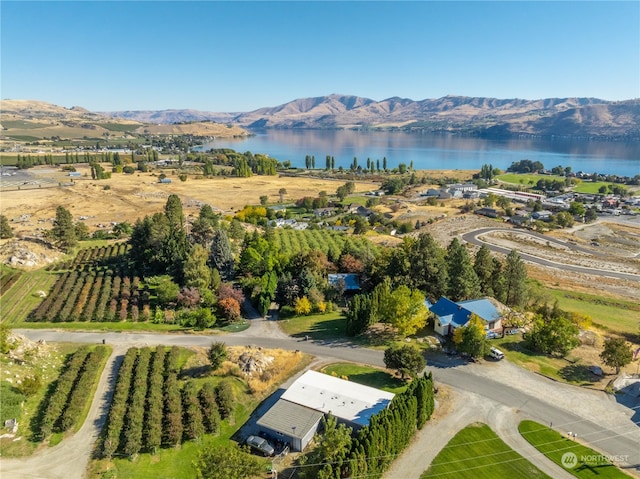 aerial view featuring a rural view and a water and mountain view