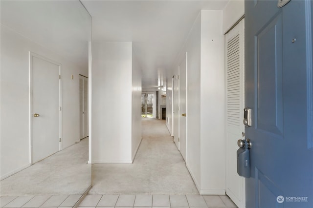 hall featuring light tile patterned floors