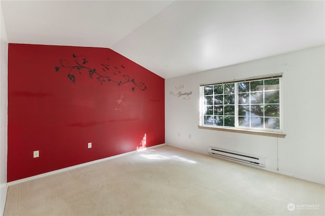 carpeted empty room featuring lofted ceiling and a baseboard heating unit