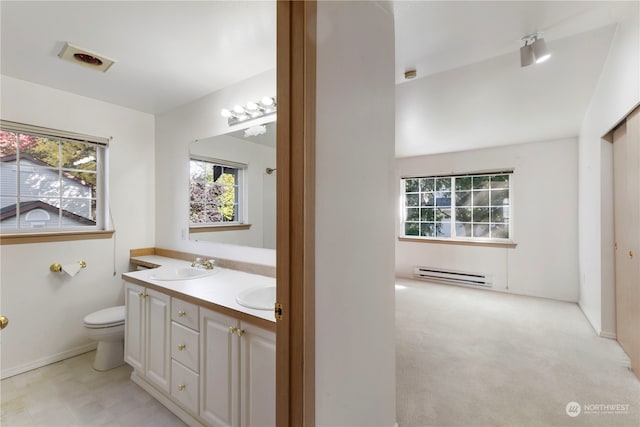 bathroom with plenty of natural light, a baseboard radiator, toilet, and vanity