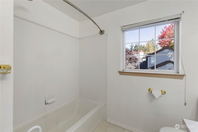 bathroom featuring tile patterned floors, shower / tub combination, and toilet