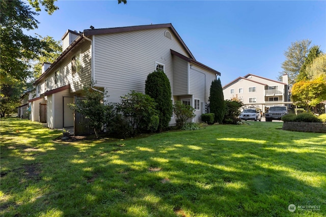 view of home's exterior with a lawn