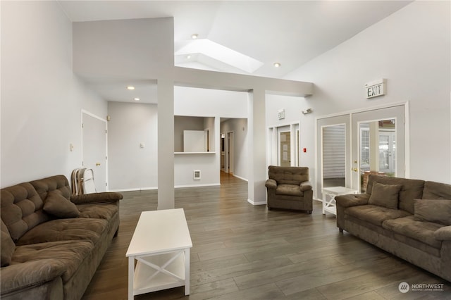 living room featuring dark wood-type flooring, french doors, high vaulted ceiling, and a skylight